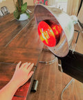 Near Infrared Therapy Bulb 250W Red Heat Lamp For Saunas Pain Relief And Skin Rejuvenation, showing lamp on table.