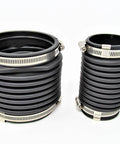 Front view of two black corrugated rubber exhaust bellows with metal hose clamps