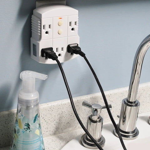 Wall-mounted Auto-Reset 15 Amp GFCI 3-Prong Grounded 5-Outlet Indoor Adapter White with plugged-in electronics by sink