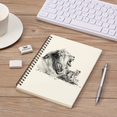 Notebook with lion drawing on desk, alongside Kneaded Art Erasers Four Pack White Soft Moldable Erasers For Charcoal Graphite And Pastel Drawing Smooth Erasing Smudge Control Precise Highlighting Easy Shaping For Pro Artists And Students, pen, cup, and keyboard.