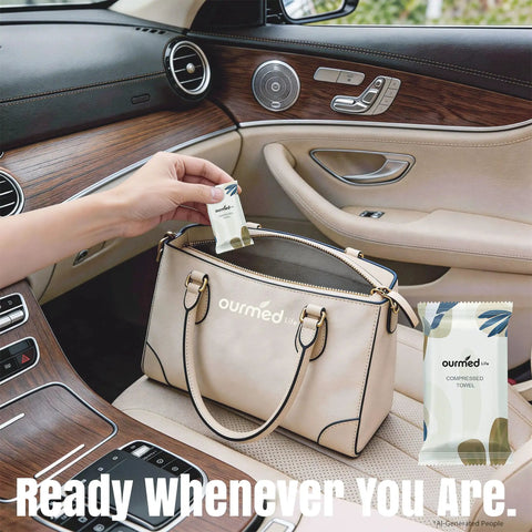 Person placing On The Go Mini Water Activated Towel Tablets in a beige purse on a car seat, showcasing product packaging.