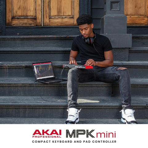 Musician using MPK Mini MK3 25 Key USB MIDI Keyboard Controller with 8 backlit drum pads and 8 knobs outdoor setup