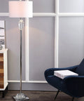 63 Inch Clear Chrome Faceted Crystal Iron LED Floor Lamp With White Linen Drum Shade in a living room next to a chair.