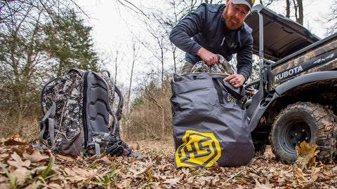 Man packing Scent Safe Deluxe Travel Scent Bag for hunting gear and clothing keeps your scent hidden and your gear scent free
