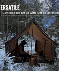 Hammock Hot Tent With Stove Jack For Winter Camping set up in snowy forest with person inside, keeping warm and dry outdoors.