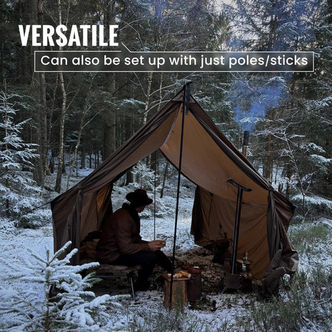 Hammock Hot Tent With Stove Jack For Winter Camping set up in snowy forest with person inside, keeping warm and dry outdoors.