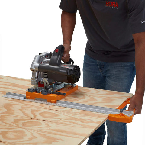 Man using Rip Guide With Saw Plate And Rip Handle For Circular Saws to make precise cuts on plywood sheet, up to 24 inches wide.