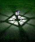 Solar Outdoor Lights 12 Pack Waterproof Pathway LED Landscape Lighting For Walkways Driveways Patios Yards And Lawns illuminated at night.