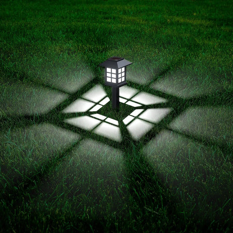 Solar Outdoor Lights 12 Pack Waterproof Pathway LED Landscape Lighting For Walkways Driveways Patios Yards And Lawns illuminated at night.