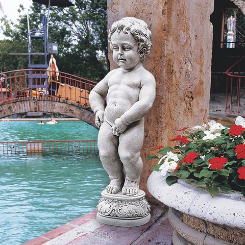 Whimsical Outdoor Piped Boy Statue Inspired By A Classic European Landmark For Garden Decor placed by a pond and flowers