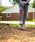 Beast Of A Compact Steel Garden Spade With Serrated Blade And Inverted V Tip For Root Removal in use on dense ground outdoors.