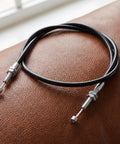 Heavy Duty Recliner Release Pull Replacement Cable, 39 Inch Length resting on brown leather surface
