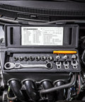Engine bay with Serpentine Belt Tool Set 15 Pc With Locking Flex Head Ratcheting Wrench and box on top of engine parts.