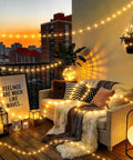 Cozy balcony at sunset with Camping String Lights 33Ft Long With 100 LEDs Rechargeable Outdoor Lights Waterproof USB Powered.