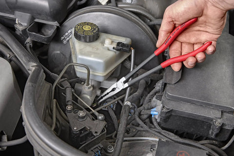 Extra Long Angled Needle Nose Pliers 11 Inch Slim Profile With Four Groove Jaws gripping small pipe in engine bay