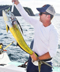 Angler holding a large fish on a boat, demonstrating effective use of 600 Piece Aluminum Fishing Crimp Sleeves Kit