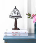 12 Inch Brown Tiffany Style Table Lamp With Ivory Cream Stained Glass Shade on blue table with books and flowers