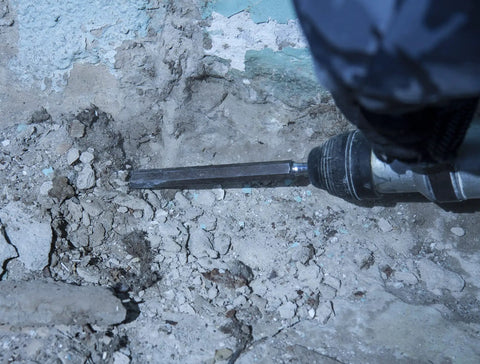 Durable SDS Plus 4 Piece Chisel Set For Hammer Drills With Thinset Scraping Bit in use on concrete surface