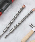 Two 1-inch x 14-inch carbide-tipped SDS-Plus rotary hammer drill bits with copper tips.