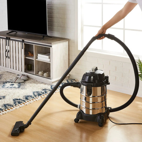Person using 6 Gallon Wet Dry Shop Vacuum Cleaner with 3.5 HP Motor, Stainless Steel Tank, Filter, and Handy Attachments in living room.