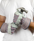 Heavy Duty Leather Palm Work Gloves 60 Pair Pack Cowhide With Suede Finish worn by person gripping hammer, cotton back visible