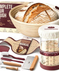 All In One Sourdough Starter Kit With 9 Inch Splinter Free Banneton Basket, tools and starter jar displayed with bread.