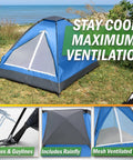 Blue two-person camping tent with rain fly on grassy field near beach, includes stakes and guy lines, mesh door for ventilation.