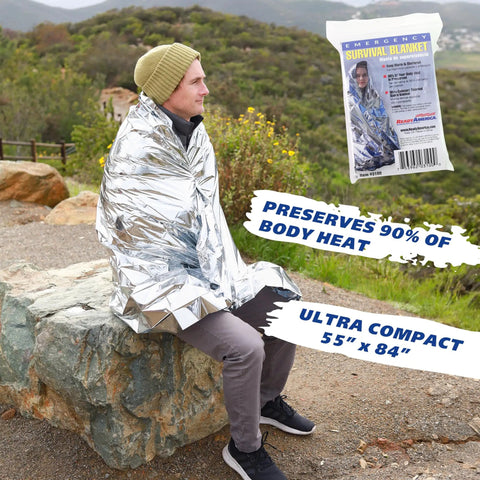 Person wrapped in foil emergency blanket in nature, 55"x84" size, part of One Person 3 Day Emergency Kit With Five Year Emergency Food And Water