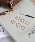 Six Pack Horseshoe Shackle Screw D Rings With Included Driver Premium Zinc Alloy Heavy Duty Hook arranged on surface.