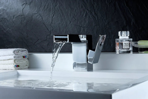 Low Arc Single Hole Waterfall Bathroom Sink Faucet In Polished Chrome Lead-Free Solid Brass Deck Mounted Lavatory Faucet With One Handle European Style Design For One Or Three Hole Installation On Point in use, water flowing into a sink.