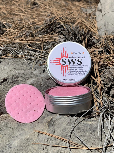 Open tin with pink disc of Eight Disc Fire Starter Kit With Waterproof And Windproof Discs Delivers 7 Minute Burns For Emergencies