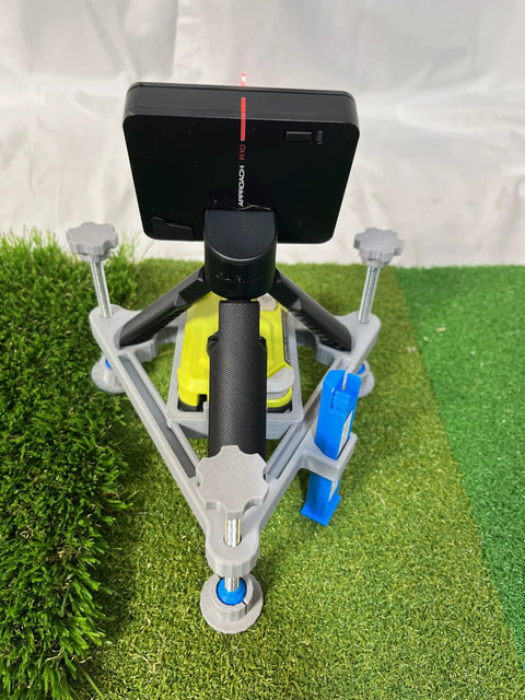 Leveling And Alignment Stand For R10 Launch Monitor compatible with Ryobi ELL1501 line pointer on grassy surface.