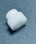 Close-up of 0.7M POM Spur Gear 26T with 8mm bore in white plastic for RC cars, showing straight teeth and smooth finish.