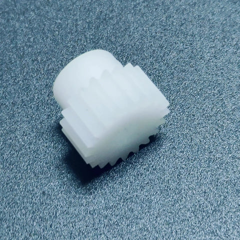 Close-up of 0.7M POM Spur Gear 26T with 8mm bore in white plastic for RC cars, showing straight teeth and smooth finish.