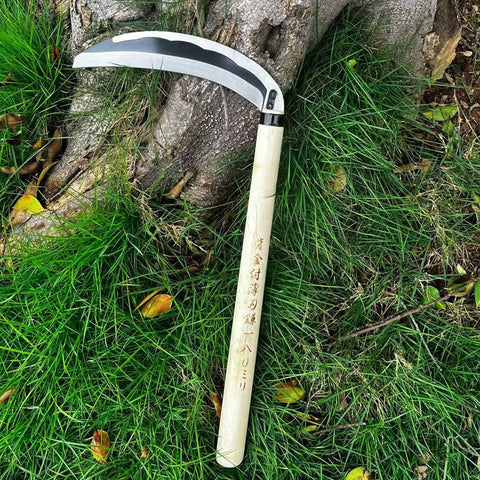Hand Hoe Sickle Garden Tool For Weeding And Cultivation, sharp blade, beige handle, on grass, tree background