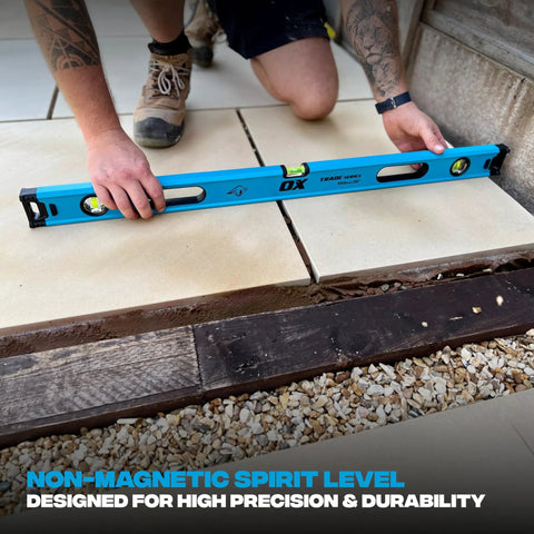 Pro Grade 2 Foot Aluminum Level Box Beam With Magnified Vials in use on tile install demonstrating precision leveling.