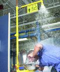 Heavy Duty Badass Industrial Combo Drench Shower And Eye Face Wash Station Galvanized Steel in use with water spray.