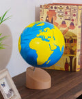Sandpaper Globe For Sensory Geography Learning Land And Water Tactile Globe In Solid Beechwood on shelf with decor