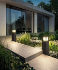 Modern home entrance with two Go-To IP54 Waterproof Outdoor Bollard Path Lights, 32-Inch Black LED Lamps, 3000K Warm White
