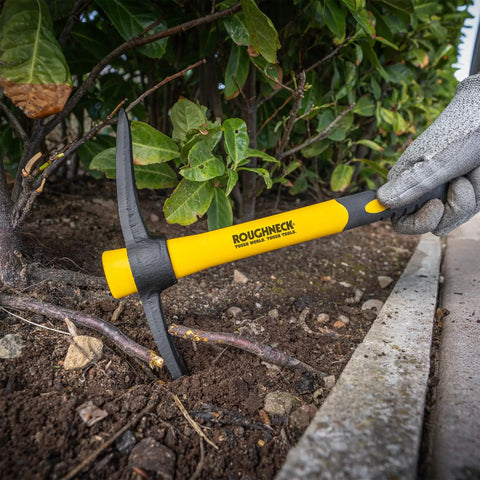 Using Micro Pick Mattock With Fiberglass Handle For Soft And Hard Ground Breaks Down Soil And Mortar in garden, yellow handle