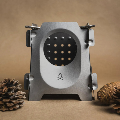Ultralight Titanium Camping Stove 7.7oz Flatpack Wood Burning Stove For Backpacking And Hiking with pine cones