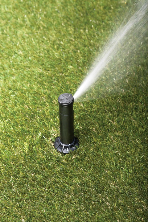Simple Adjust Gear Drive Rotor 32SA spraying water on grass, adjustable 40 to 360 degree pattern, 19 to 32 feet spray distance