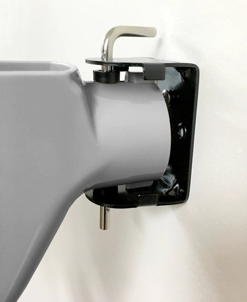 Wall-mounted side view of Wonder Winder Grab And Go Hand Crank Extension Cord Winder in heavy duty gray.