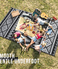 Family picnic on Waterproof Reversible Outdoor Rug 5x8 Ft Made From Recycled Plastic Straws Dope Boho Black And White Patio Carpet