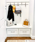 Entryway with Milano Door And Drawer Pull 8 Inch Center-To-Center in Oil Rubbed Bronze on white drawers under coat and bag rack
