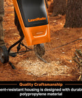 Electric Wood Chipper Shredder for Yard Cleanup with 15 Amp Motor in operation, chipping branches, built tough with durable poly housing.