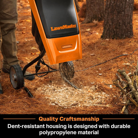 Electric Wood Chipper Shredder for Yard Cleanup with 15 Amp Motor in operation, chipping branches, built tough with durable poly housing.
