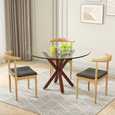 Round glass tabletop on a wooden base with chairs, highlighting dining setup.