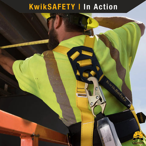 Rock Solid 6 Foot Flat Safety Lanyard With Quick Deploy Shock Absorber And Heavy Duty Yellow Webbing used on a construction site by a worker.