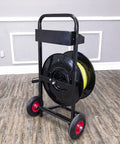 Top Shelf Banding Strapping Cart For Steel And Poly Strap Rolls, Hassle Free Dolly With Lockdown Brake and Roomy Tool Bin, sturdy metal frame with wheels holding strap reel.